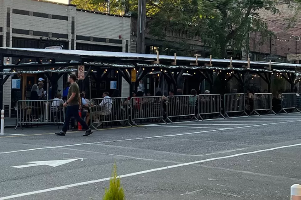 Covered pergolas for outdoor dining line the curb on Ballard Avenue, Seattle